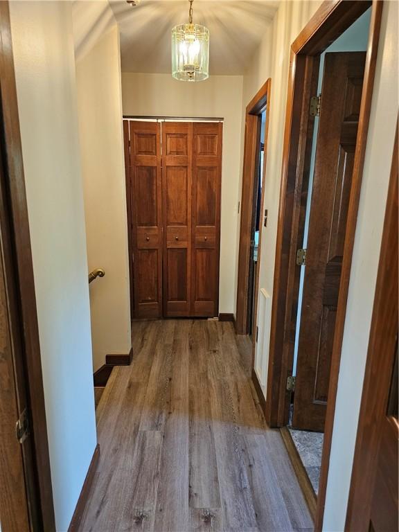 818 Larchmont Cir, Elmira, NY 14905 - hallway with wood finished floors and a chandelier