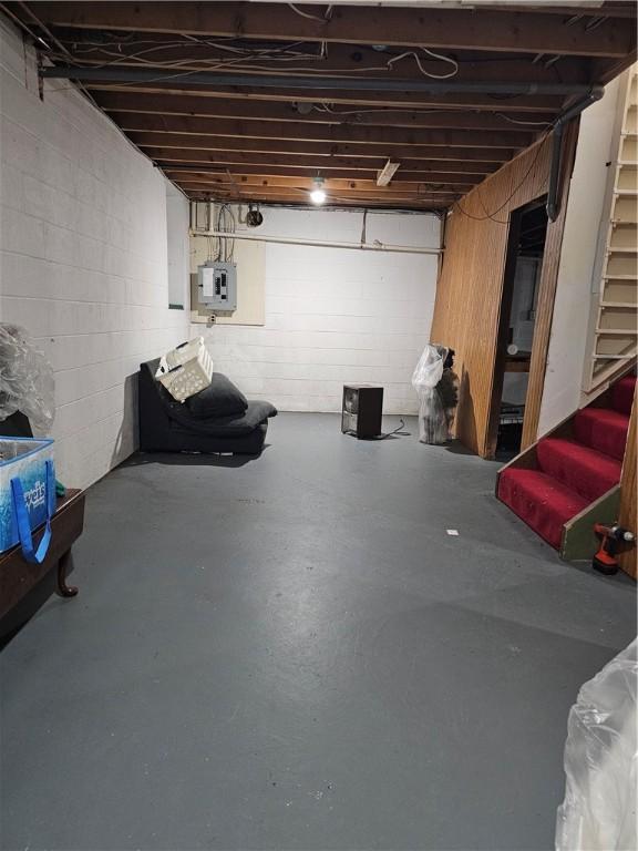 818 Larchmont Cir, Elmira, NY 14905 - unfinished basement with stairs, electric panel, and concrete block wall