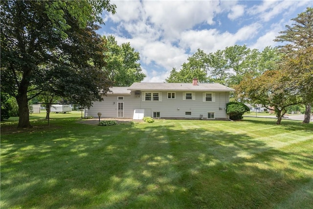 6 Meadowbrook Ter, North Dansville, NY 14437 - rear view of house with a lawn, a patio area, and a chimney