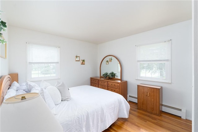 6 Meadowbrook Ter, North Dansville, NY 14437 - bedroom featuring baseboard heating, multiple windows, and light wood finished floors