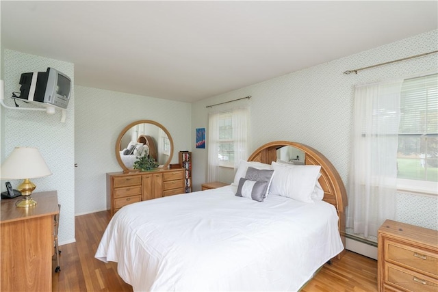 6 Meadowbrook Ter, North Dansville, NY 14437 - bedroom with wallpapered walls, wood finished floors, and baseboard heating