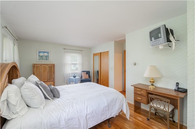 6 Meadowbrook Ter, North Dansville, NY 14437 - bedroom featuring wood finished floors, wallpapered walls, and a closet