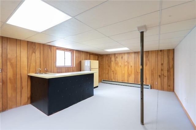 6 Meadowbrook Ter, North Dansville, NY 14437 - bar with a baseboard radiator, freestanding refrigerator, wood walls, and a drop ceiling