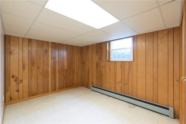6 Meadowbrook Ter, North Dansville, NY 14437 - basement featuring baseboard heating, a paneled ceiling, and wooden walls