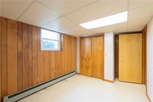 6 Meadowbrook Ter, North Dansville, NY 14437 - basement featuring baseboard heating, a paneled ceiling, carpet, and wooden walls