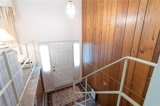 6 Meadowbrook Ter, North Dansville, NY 14437 - entryway with wood walls, a baseboard heating unit, and carpet floors