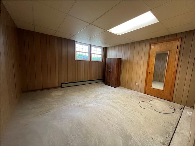 6 Meadowbrook Ter, North Dansville, NY 14437 - unfurnished room featuring a baseboard radiator, a drop ceiling, and wooden walls