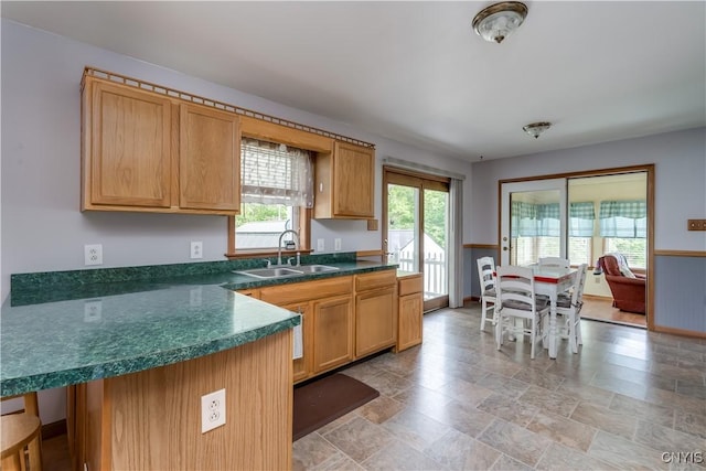 60 Van Buren St, Antwerp, NY 13608 - kitchen featuring dark countertops, light stone finish floors, and a peninsula