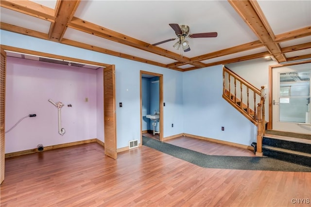60 Van Buren St, Antwerp, NY 13608 - unfurnished living room with coffered ceiling, light wood-type flooring, stairway, beamed ceiling, and a ceiling fan