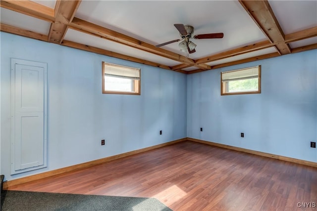 60 Van Buren St, Antwerp, NY 13608 - empty room with coffered ceiling, light wood-style floors, healthy amount of natural light, beam ceiling, and a ceiling fan