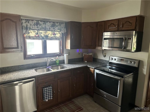 115 N 17th St, Olean-City, NY 14760 - kitchen featuring stainless steel appliances, dark brown cabinetry, and light tile patterned floors