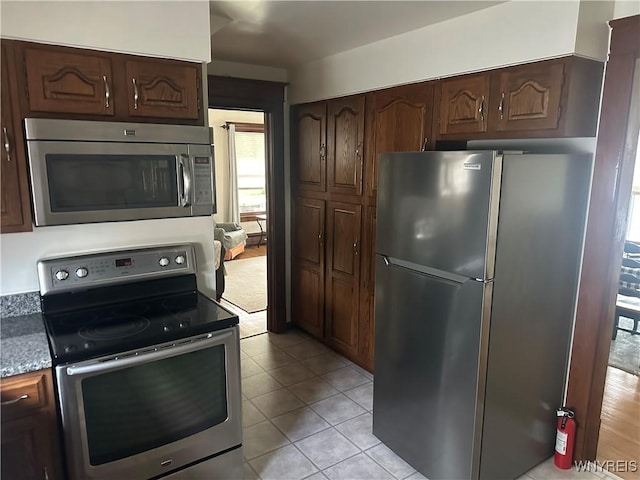 115 N 17th St, Olean-City, NY 14760 - kitchen featuring appliances with stainless steel finishes, dark brown cabinets, and light tile patterned floors