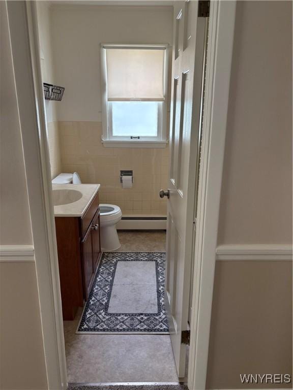 115 N 17th St, Olean-City, NY 14760 - bathroom featuring a baseboard radiator, vanity, tile walls, and tile patterned flooring