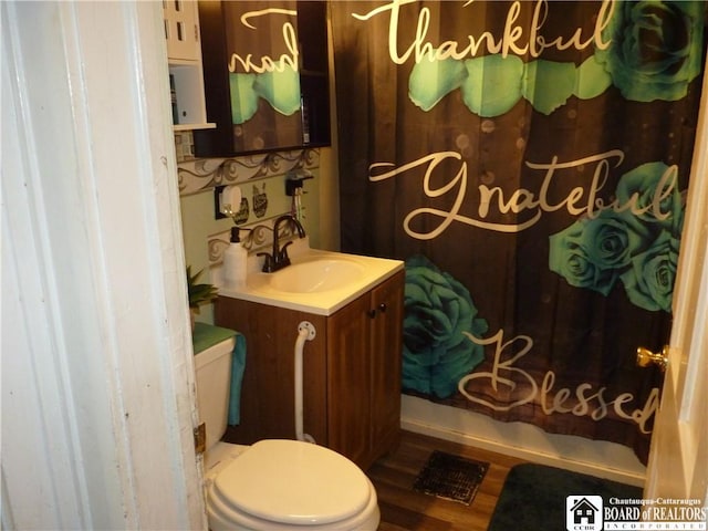 174 Bowen St, Jamestown, NY 14701 - full bath with vanity, shower / bath combo with shower curtain, and wood finished floors