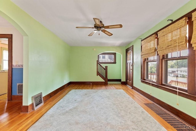 217 Mackay Ave, Camillus, NY 13219 - spare room featuring arched walkways, wood finished floors, plenty of natural light, and ceiling fan