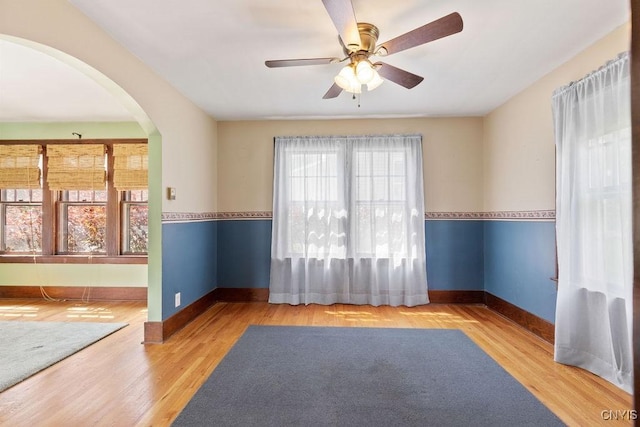 217 Mackay Ave, Camillus, NY 13219 - spare room with arched walkways, ceiling fan, and wood finished floors