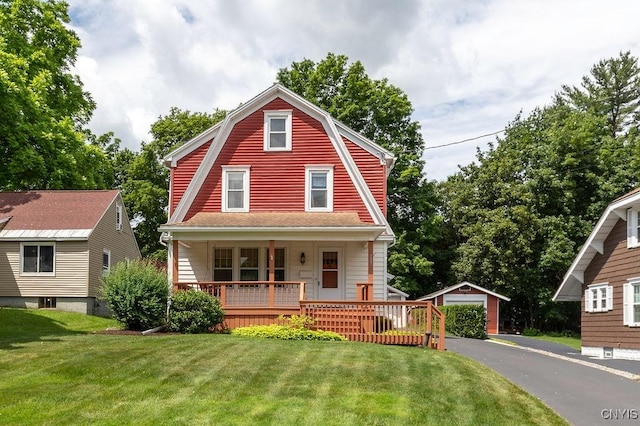217 Mackay Ave, Camillus, NY 13219 - colonial inspired home with an outdoor structure, covered porch, a front yard, a detached garage, and a gambrel roof