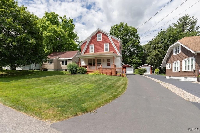 217 Mackay Ave, Camillus, NY 13219 - dutch colonial featuring a gambrel roof, covered porch, a front lawn, and an outdoor structure