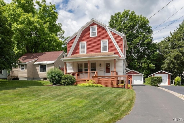 217 Mackay Ave, Camillus, NY 13219 - dutch colonial featuring a detached garage, a porch, an outbuilding, a front yard, and a gambrel roof