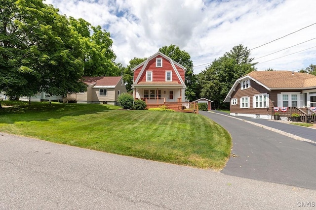 217 Mackay Ave, Camillus, NY 13219 - colonial inspired home with a gambrel roof, a porch, an outbuilding, and a front yard
