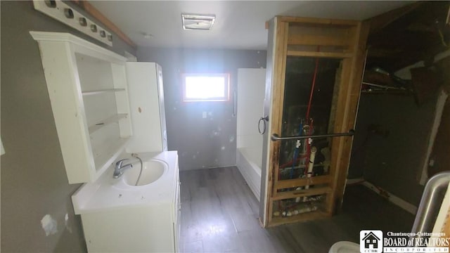 4010 Main St, Scio, NY 14880 - bathroom featuring vanity, a bath, and wood finished floors