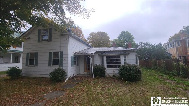4010 Main St, Scio, NY 14880 - traditional-style house with a chimney and a metal roof