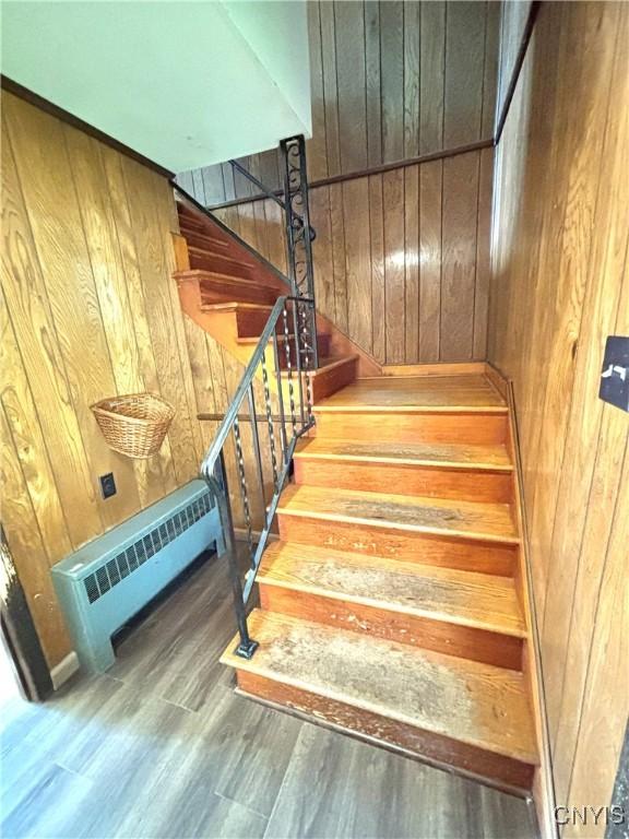 6473 Wembridge Dr, Dewitt, NY 13057 - stairway featuring wooden walls and wood finished floors