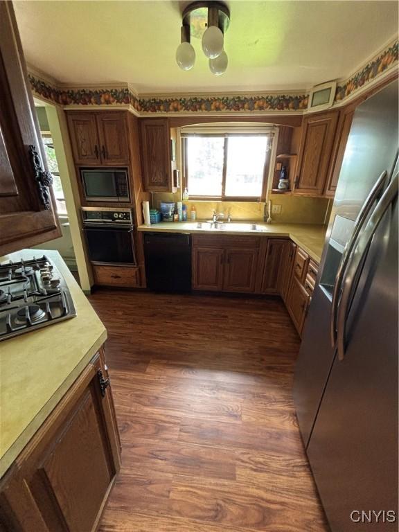 6473 Wembridge Dr, Dewitt, NY 13057 - kitchen with black appliances, light countertops, dark wood finished floors, and open shelves