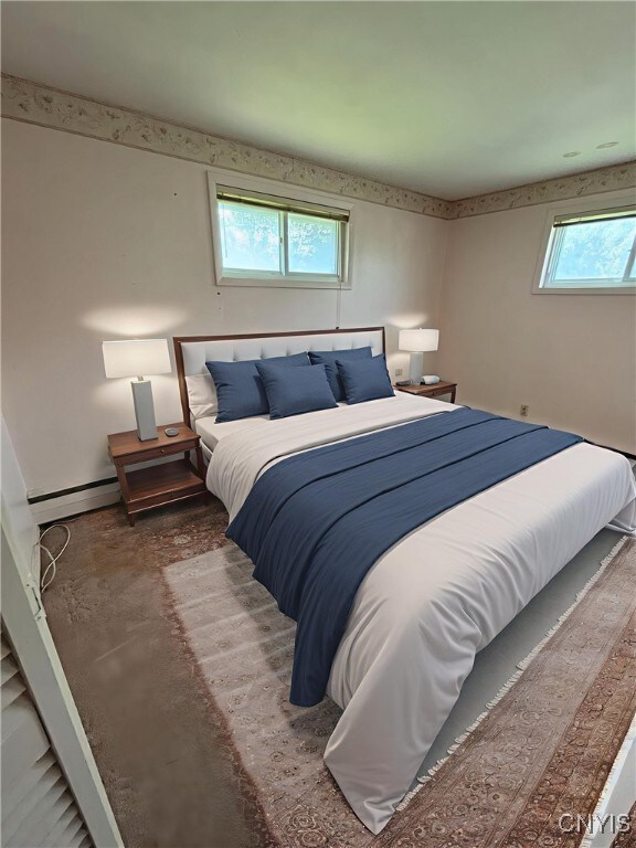 6473 Wembridge Dr, Dewitt, NY 13057 - bedroom featuring baseboard heating and concrete floors