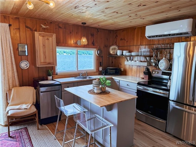 15794 W Lake Rd, Pulteney, NY 14874 - kitchen featuring appliances with stainless steel finishes, a wall mounted air conditioner, butcher block countertops, wooden ceiling, and wood walls