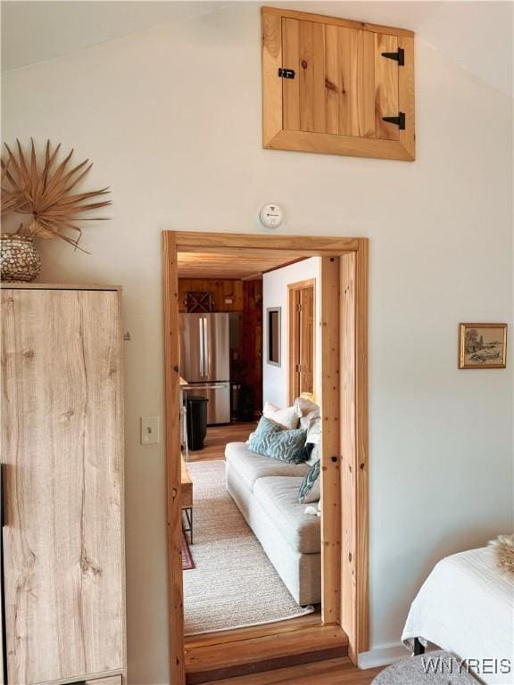 15794 W Lake Rd, Pulteney, NY 14874 - bedroom featuring freestanding refrigerator, wood finished floors, and lofted ceiling