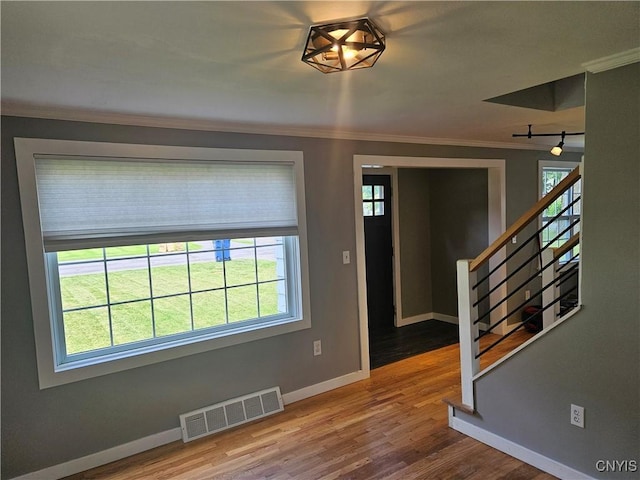 203 Windemere Rd, Geddes, NY 13219 - spare room featuring crown molding, stairs, plenty of natural light, and wood finished floors