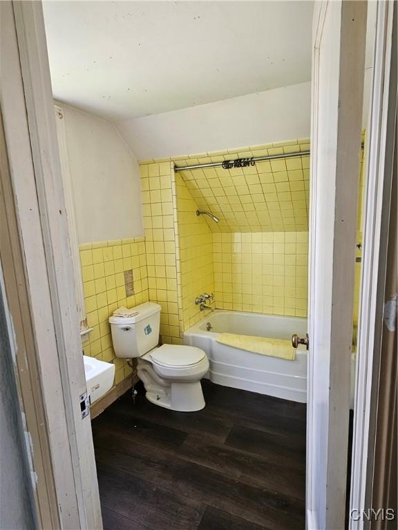 203 Windemere Rd, Geddes, NY 13219 - bathroom with wood finished floors, tile walls, lofted ceiling, and  shower combination