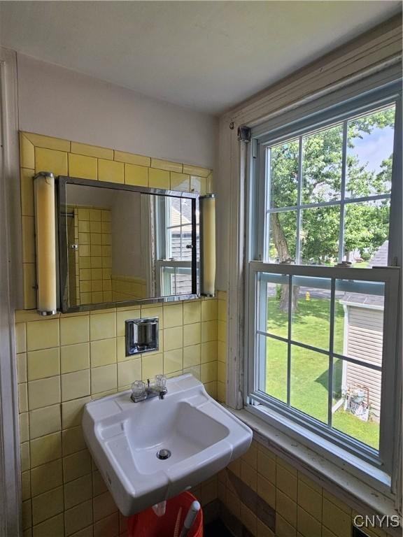 203 Windemere Rd, Geddes, NY 13219 - bathroom featuring plenty of natural light and tile walls