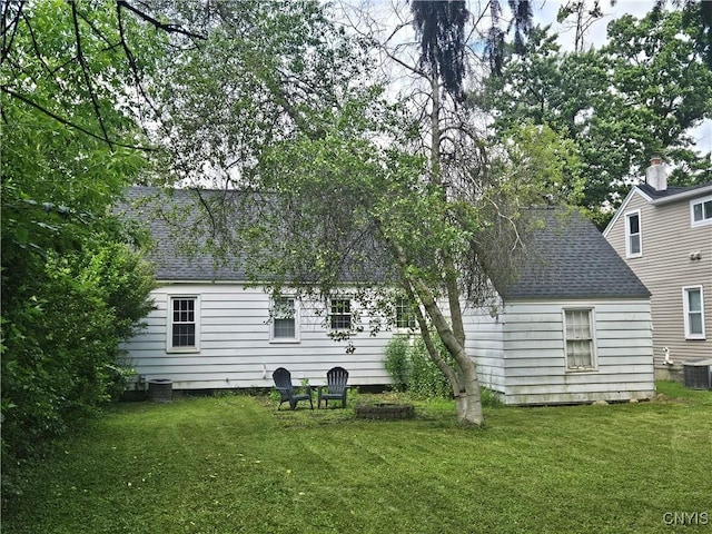 203 Windemere Rd, Geddes, NY 13219 - back of house featuring a shingled roof and a lawn