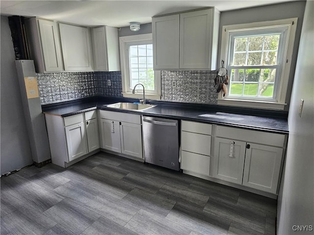 203 Windemere Rd, Geddes, NY 13219 - kitchen featuring stainless steel dishwasher, dark countertops, and backsplash