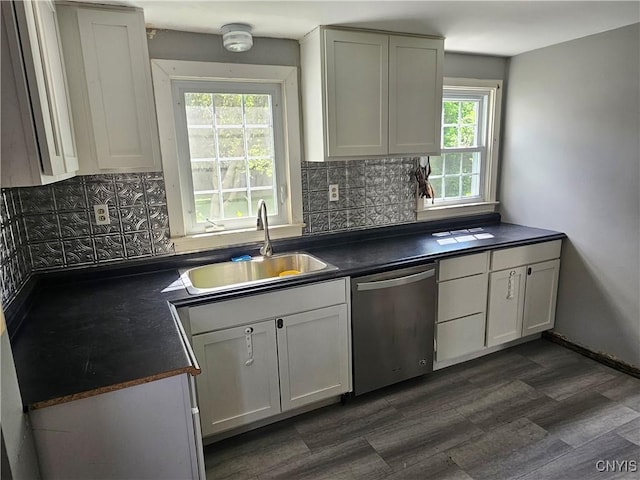203 Windemere Rd, Geddes, NY 13219 - kitchen with stainless steel dishwasher, dark countertops, decorative backsplash, and white cabinets
