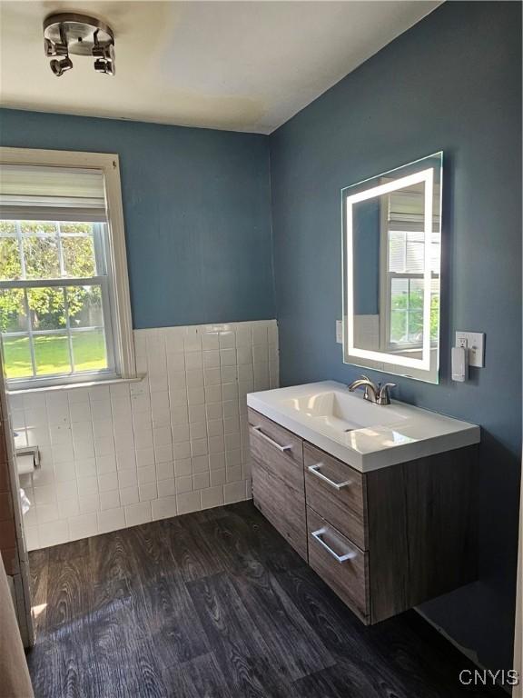 203 Windemere Rd, Geddes, NY 13219 - bathroom with vanity, wood finished floors, and wainscoting