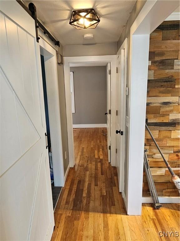 203 Windemere Rd, Geddes, NY 13219 - hallway with a barn door and wood finished floors