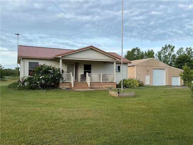 13810 Waterport Carlton Rd, Carlton, NY 14411 - ranch-style house featuring covered porch, a detached garage, a front yard, a metal roof, and an outbuilding