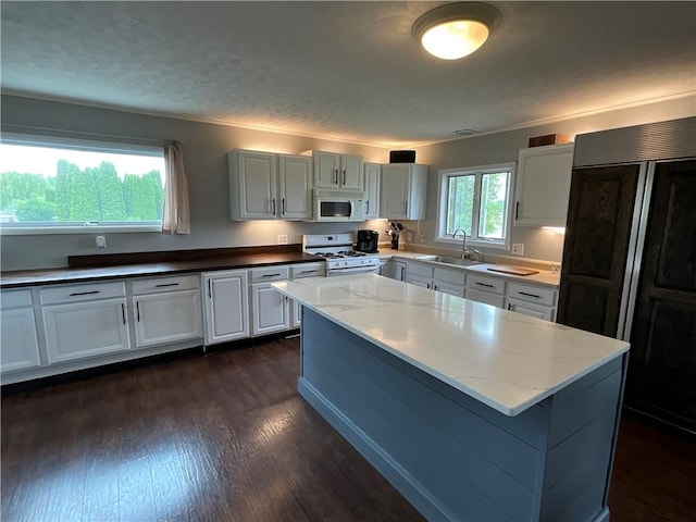 13810 Waterport Carlton Rd, Carlton, NY 14411 - kitchen with white appliances, light stone counters, dark wood-style flooring, and white cabinetry