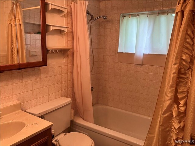 1300 Cain Rd, Porter, NY 14174 - bathroom featuring tile walls, shower / bathtub combination with curtain, and vanity