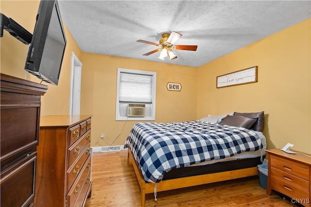 10327 Wolcott Hill Rd, Camden, NY 13316 - bedroom featuring light wood-type flooring, a textured ceiling, cooling unit, and a ceiling fan