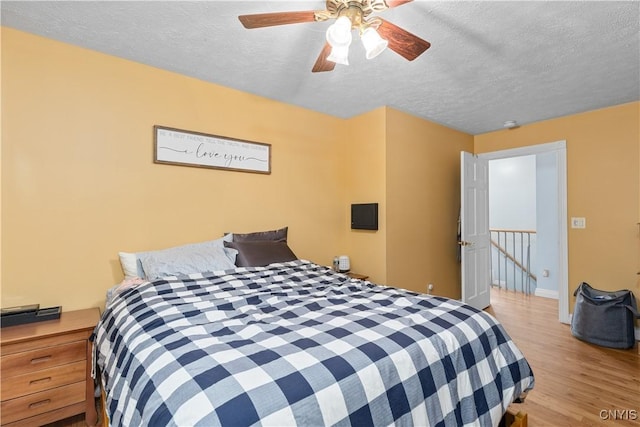 10327 Wolcott Hill Rd, Camden, NY 13316 - bedroom featuring a textured ceiling, wood finished floors, and ceiling fan