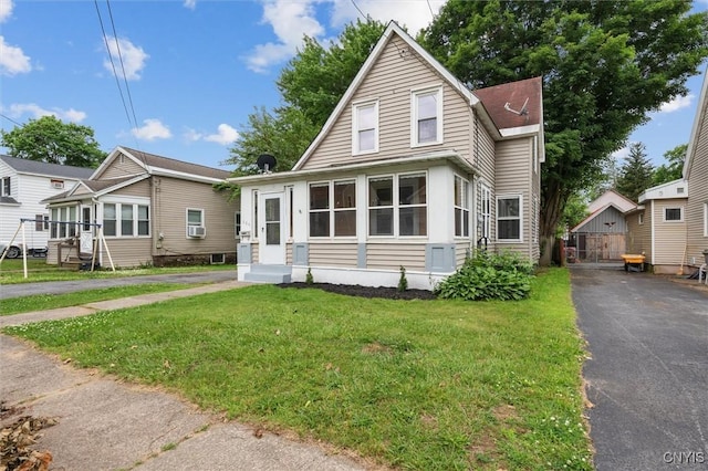364 S 6th St, Fulton, NY 13069 - bungalow-style house featuring entry steps, driveway, a front lawn, an outbuilding, and cooling unit
