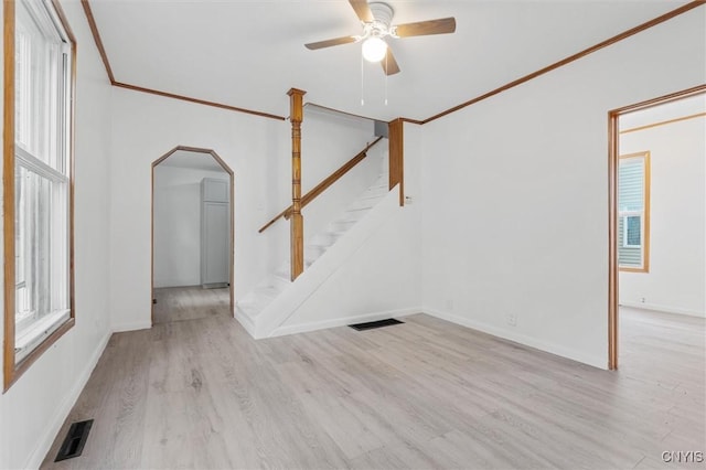 364 S 6th St, Fulton, NY 13069 - unfurnished living room with stairway, crown molding, wood finished floors, ceiling fan, and arched walkways