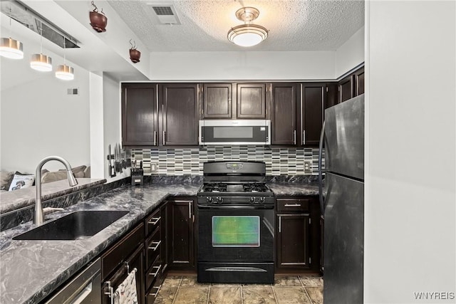 75B Foxberry Dr, Amherst, NY 14068 - kitchen featuring stainless steel appliances, tasteful backsplash, dark brown cabinetry, a textured ceiling, and dark stone countertops