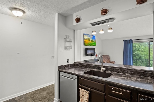 75B Foxberry Dr, Amherst, NY 14068 - kitchen with dark countertops, a glass covered fireplace, dark brown cabinets, dishwasher, and a textured ceiling