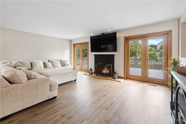 4925 Bentbrook Dr, Manlius, NY 13104 - living area featuring a brick fireplace, wood finished floors, and recessed lighting