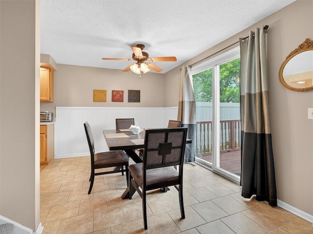 54 Flower Dale Cir, Greece, NY 14626 - dining area featuring a wainscoted wall, ceiling fan, a textured ceiling, and light tile patterned floors